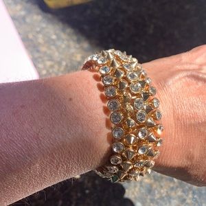 Stretch gold tone  with 3 rows of rhinestones. Heavy weight